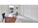 Office features a large desk, a white shelving unit, soft carpeting, and natural light at 8060 E Girard Ave # 311, Denver, CO 80231