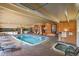 Indoor pool and hot tub with lounge chairs and tables for year-round enjoyment at 8060 E Girard Ave # 311, Denver, CO 80231