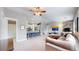 Spacious living room featuring a stone fireplace and open layout to the kitchen at 18274 W 58Th Pl # 37, Golden, CO 80403