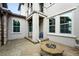 Inviting back porch with decorative stone accents, stylish lighting, and a cozy outdoor fireplace at 15377 W Iliff Dr, Denver, CO 80228