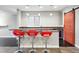 Stylish bar area with seating, custom lighting, and sliding barn door at 15377 W Iliff Dr, Denver, CO 80228