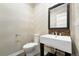 Contemporary half-bathroom features a modern sink, stylish faucet, and decorative mirror at 15377 W Iliff Dr, Denver, CO 80228