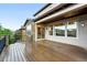 Spacious deck is perfect for outdoor living with stone and siding exterior home with mountain views at 15377 W Iliff Dr, Denver, CO 80228