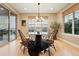 Bright dining area with large windows and a sliding glass door with an outdoor view at 15377 W Iliff Dr, Denver, CO 80228