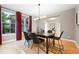 Bright dining room features stylish chandelier, modern decor, neutral paint, and large windows for natural light at 15377 W Iliff Dr, Denver, CO 80228