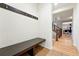 Inviting entryway with built-in bench, hooks, and hardwood floors at 15377 W Iliff Dr, Denver, CO 80228