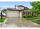 Charming two-story home featuring a three-car garage, stone accents and a basketball hoop at 15377 W Iliff Dr, Denver, CO 80228