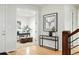 Welcoming foyer with hardwood floors, modern console, and office view at 15377 W Iliff Dr, Denver, CO 80228