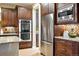 Close-up of a kitchen area with built-in stainless appliances and custom backsplash at 15377 W Iliff Dr, Denver, CO 80228