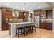 Gourmet kitchen featuring stainless steel appliances, a large island, and custom cabinetry at 15377 W Iliff Dr, Denver, CO 80228