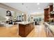 Spacious kitchen featuring a large island, hardwood floors, and an open floor plan at 15377 W Iliff Dr, Denver, CO 80228