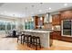 Modern kitchen with granite countertops, stainless steel appliances, and an adjacent dining area at 15377 W Iliff Dr, Denver, CO 80228
