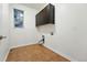 Bright laundry room with built-in cabinets and tile flooring at 15377 W Iliff Dr, Denver, CO 80228