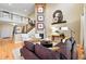 Inviting living room with high ceilings, hardwood floors, comfortable seating, and a view to upstairs at 15377 W Iliff Dr, Denver, CO 80228