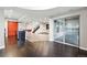 Spacious living room with modern finishes, open layout, and stylish kitchen with red stools at 15377 W Iliff Dr, Denver, CO 80228