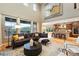 Bright living room with large windows, hardwood floors, open concept to the kitchen, and mountain views at 15377 W Iliff Dr, Denver, CO 80228