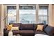 Cozy living room with expansive windows offering breathtaking views of the lake and mountains at 15377 W Iliff Dr, Denver, CO 80228