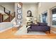 Elegant living room featuring high ceilings, hardwood floors, cozy seating, and fireplace at 15377 W Iliff Dr, Denver, CO 80228