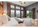 Bright and airy main bedroom showcases large windows with mountain views and a ceiling fan at 15377 W Iliff Dr, Denver, CO 80228