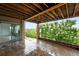 Covered patio with a wood ceiling, stone pillars, and serene outdoor view at 15377 W Iliff Dr, Denver, CO 80228