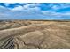 Broad aerial view of a rural landscape featuring rolling plains and distant mountain views at 754 Highway 86 Hwy, Elizabeth, CO 80107