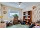 Bedroom with window, ceiling fan, and wallpaper, showcasing a storage unit and dresser at 754 Highway 86 Hwy, Elizabeth, CO 80107
