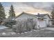 Shot of home with a side garage, small garden, and lush green trees at 754 Highway 86 Hwy, Elizabeth, CO 80107