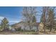 Exterior shot of home with side garage, lush green trees, and small garden at 754 Highway 86 Hwy, Elizabeth, CO 80107