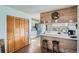 Charming kitchen with a breakfast bar, wood paneling, and ample cabinet space for storage at 754 Highway 86 Hwy, Elizabeth, CO 80107