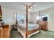 Cozy main bedroom featuring a four-poster bed, classic decor, and windows that fill the room with light at 754 Highway 86 Hwy, Elizabeth, CO 80107