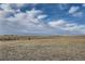 Vast open field with scattered trees under a cloudy sky presents possibilities for development at 754 Highway 86 Hwy, Elizabeth, CO 80107
