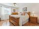 Bright bedroom boasts hardwood floors, natural wood furniture, and a plush bed at 13106 W Chenango Ave, Morrison, CO 80465