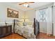 Quaint bedroom with a decorative bed frame, hardwood floors, and large windows for natural light at 13106 W Chenango Ave, Morrison, CO 80465