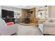 Comfortable living room features a stone fireplace, built-in shelving, and soft neutral colors at 13106 W Chenango Ave, Morrison, CO 80465
