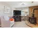 Cozy living room with a brick fireplace, soft lighting, and comfortable seating at 13106 W Chenango Ave, Morrison, CO 80465