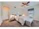 Bedroom featuring a ceiling fan, neutral color palette, window and an ensuite bath entrance at 3792 S Dallas St, Aurora, CO 80014