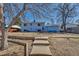 The backyard shows tiered landscaping leading up to a two-story home with ample space for outdoor activities at 15640 E Eldorado Dr, Aurora, CO 80013