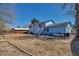 Large backyard with a blue two-story house and a wooden fence, offering outdoor living and privacy at 15640 E Eldorado Dr, Aurora, CO 80013