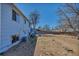 Expansive backyard view featuring a two-story blue house and fenced yard, ready for landscaping and outdoor enjoyment at 15640 E Eldorado Dr, Aurora, CO 80013