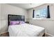 Cozy bedroom featuring a comfortable bed, soft pillows, and natural light from the window at 15640 E Eldorado Dr, Aurora, CO 80013