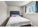 Cozy bedroom featuring a comfortable bed, soft pillows, and natural light from the window at 15640 E Eldorado Dr, Aurora, CO 80013
