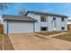 Charming two-story home features a light blue exterior, attached garage, and well-lit entrance at 15640 E Eldorado Dr, Aurora, CO 80013