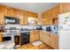 Functional kitchen features classic cabinetry, stainless steel appliances, and laminate countertops at 15640 E Eldorado Dr, Aurora, CO 80013
