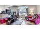 Cozy living room features hardwood floors, bright windows, and comfortable seating area at 15640 E Eldorado Dr, Aurora, CO 80013