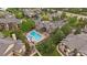 Aerial view of community pool, landscaped grounds, pool-side seating, and manicured walkways at 7413 S Quail Cir # 1435, Littleton, CO 80127