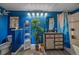 Colorful bathroom with a wooden vanity, overhead lighting, and vibrant blue walls at 7413 S Quail Cir # 1435, Littleton, CO 80127