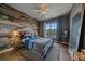 Cozy bedroom with stylish wood accent wall, ceiling fan, and plush rug at 7413 S Quail Cir # 1435, Littleton, CO 80127