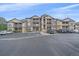 Attractive condo building with a parking lot and balconies on a sunny day at 7413 S Quail Cir # 1435, Littleton, CO 80127
