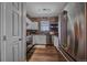 Modern kitchen featuring stainless steel appliances, white cabinets, and brick backsplash at 7413 S Quail Cir # 1435, Littleton, CO 80127