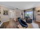 A cozy living room featuring modern decor, wood floors, and a sliding glass door to the balcony at 7413 S Quail Cir # 1435, Littleton, CO 80127